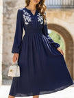 Light blue embroidered waist V-neck dress by FJØRNA, featuring a flattering silhouette and intricate embroidery details.