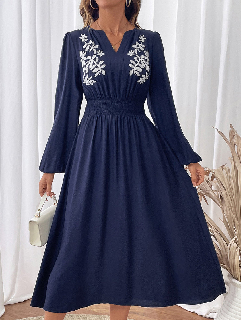 Light blue embroidered waist V-neck dress by FJØRNA, featuring a flattering fit and intricate embroidery details.