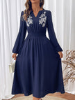 Light blue embroidered waist V-neck dress by FJØRNA, showcasing intricate embroidery and elegant fit.
