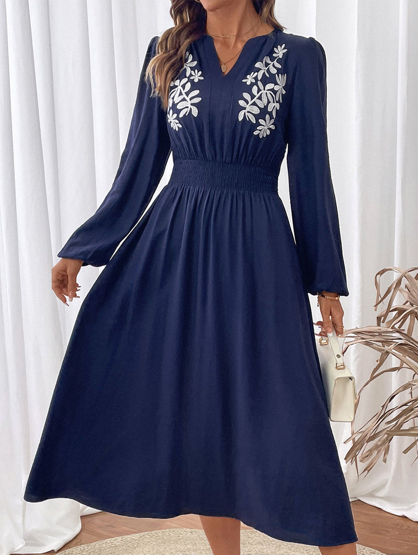 Light blue embroidered waist V-neck dress by FJØRNA, showcasing intricate embroidery and elegant design.