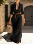 Black FJØRNA solid color irregular pleated dress with a flowing design and unique pleats, perfect for elegant occasions.