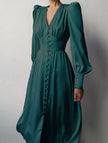 White FJØRNA retro V-neck waist dress displayed on a model, featuring a fitted silhouette and classic design.