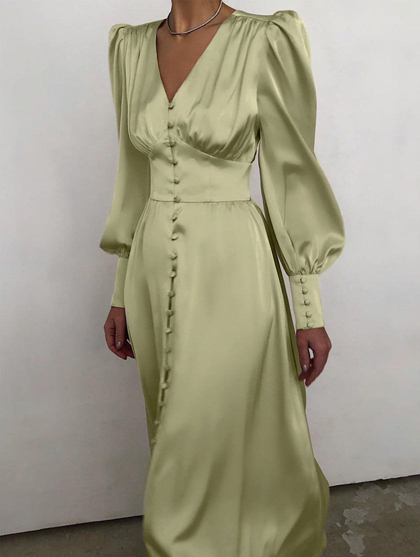 White retro V-neck waist dress by FJØRNA, featuring a fitted silhouette and classic design, shown on a model.