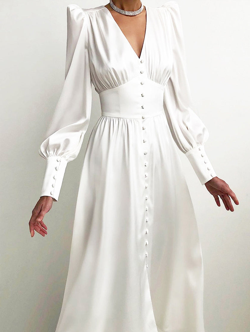 White FJØRNA retro V-neck waist dress displayed on a hanger, showcasing its classic design and fitted silhouette.