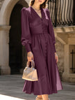 White retro V-neck waist dress by FJØRNA, featuring a flattering fit and classic design, displayed on a mannequin.