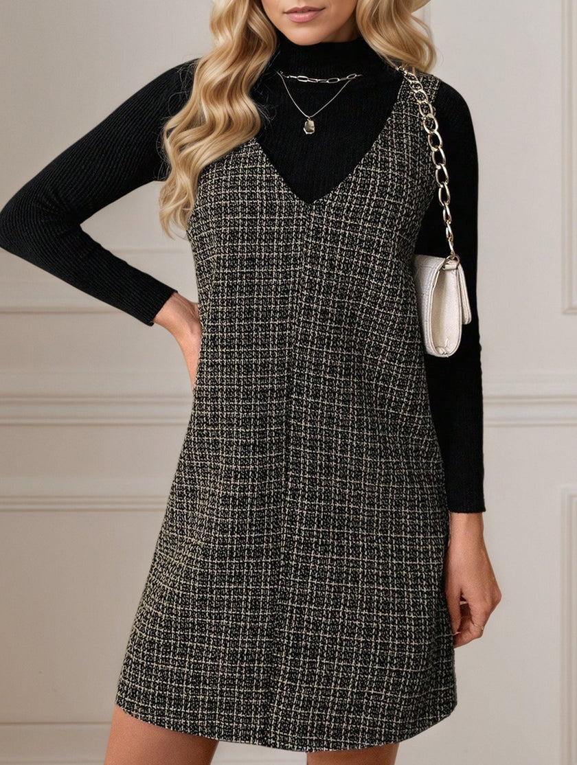 White FJØRNA sleeveless midi dress with suspenders and V-neck, displayed hanging on a mannequin.