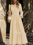 FJØRNA white V-neck pleated waist tiered long-sleeved dress displayed on a hanger, showcasing its elegant design and fabric details.