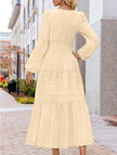 FJØRNA white V-neck pleated waist tiered long-sleeved dress with a flowing silhouette and elegant design.