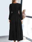 FJØRNA white V-neck pleated waist tiered long-sleeved dress, elegant and flowy, shown in a close-up of the dress fabric and design.