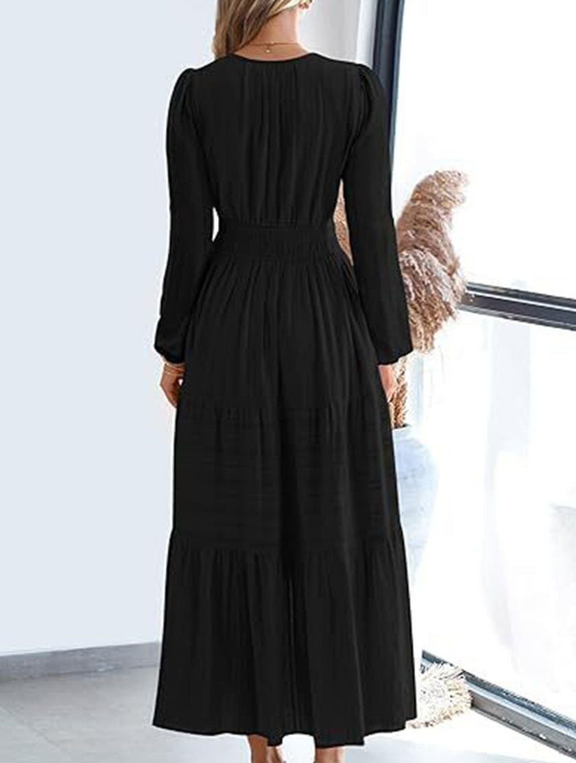 FJØRNA white V-neck pleated waist tiered long-sleeved dress, elegant and flowy, shown in a close-up of the dress fabric and design.
