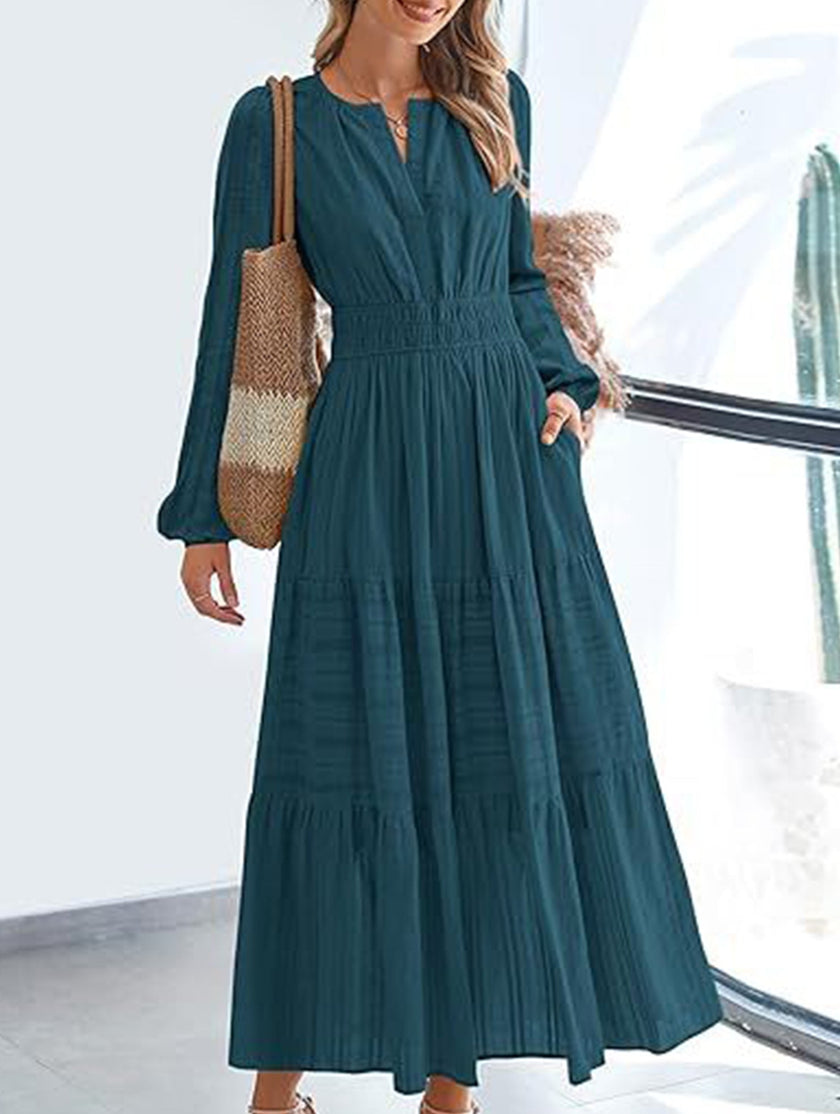 FJØRNA white V-neck pleated waist tiered long-sleeved dress, elegant and flowing with a fitted bodice and layered skirt.