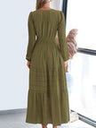 FJØRNA white V-neck pleated waist tiered long-sleeved dress displayed on a hanger with a focus on the dress details.