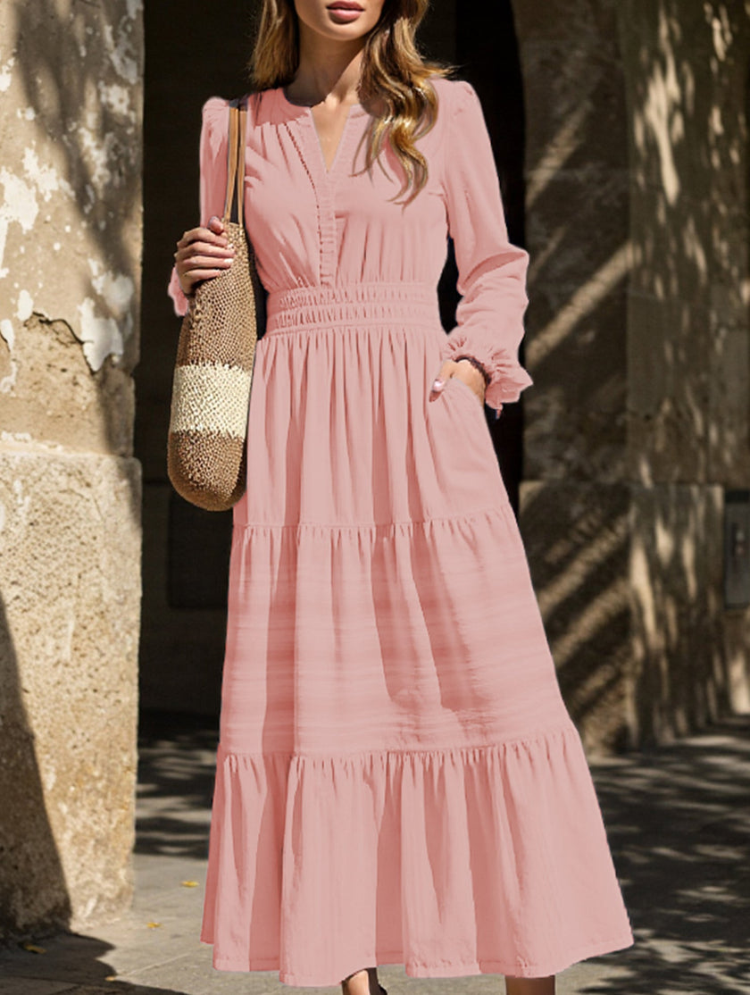 FJØRNA white V-neck pleated waist tiered long-sleeved dress, elegant and flowy, with a feminine silhouette and soft fabric.