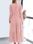 FJØRNA white V-neck pleated waist tiered long-sleeved dress displayed on a hanger.
