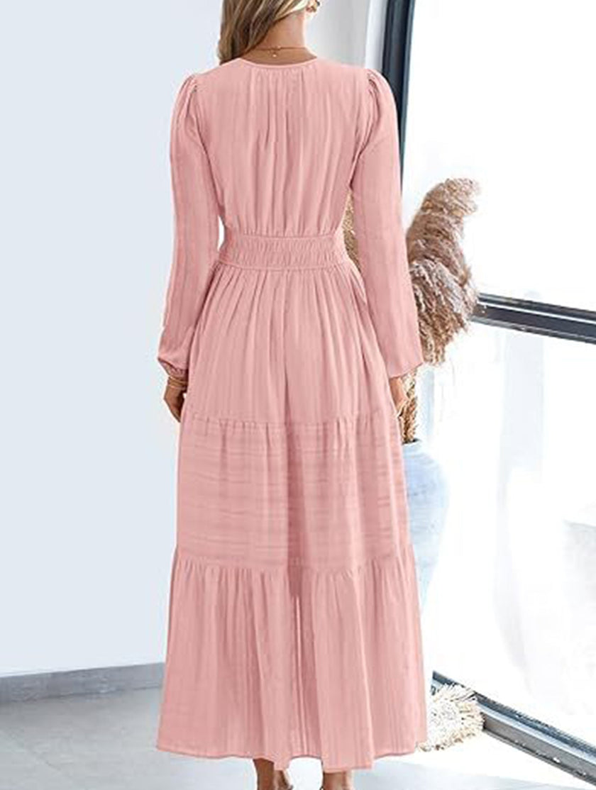 FJØRNA white V-neck pleated waist tiered long-sleeved dress displayed on a hanger.