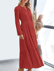 White V-neck pleated waist tiered long-sleeved dress by FJØRNA, featuring a flowing silhouette and elegant design.