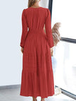 White V-neck pleated waist tiered long-sleeved dress by FJØRNA, featuring a flowy silhouette and elegant design.