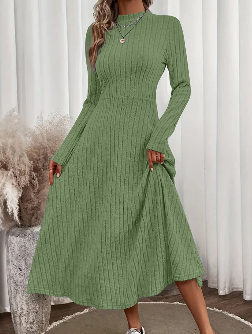 White FJØRNA round neck brushed ribbed long dress displayed on a hanger, showcasing its soft, textured fabric and relaxed fit.