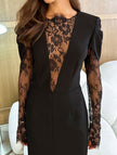 Black FJØRNA openwork dress with lace slit and cinched waist, featuring stylish detail and elegant fit.