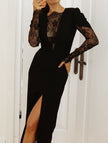 Black FJØRNA openwork dress with lace slit and cinched waist, featuring a stylish, fitted design and elegant details.