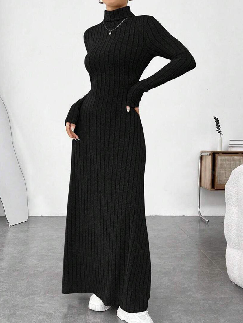 Black ribbed brushed long-sleeved dress by FJØRNA, featuring a solid color and fitted design, worn on a model.