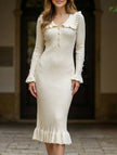 White retro ruffled knit dress by FJØRNA, showcasing its textured fabric and playful ruffle details.