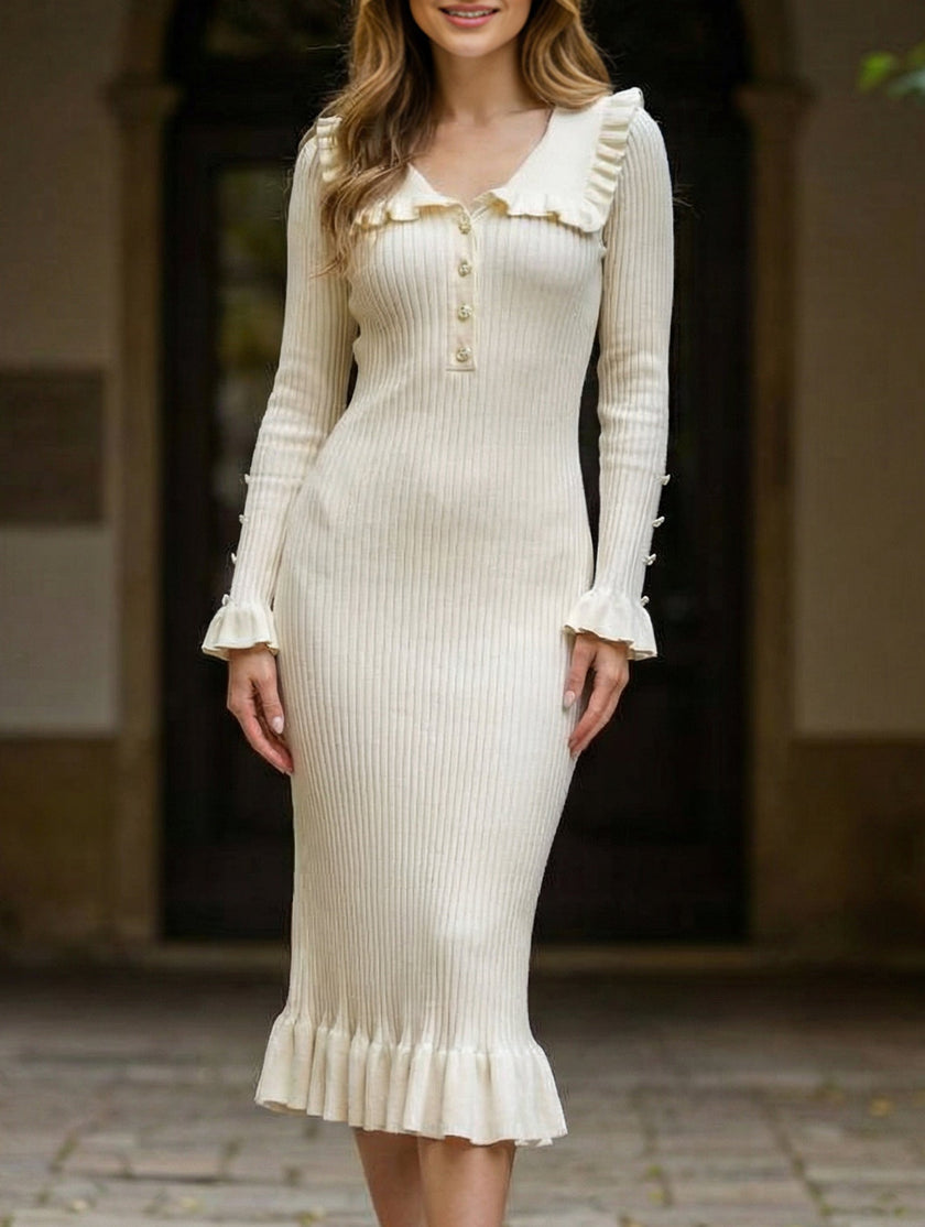 White retro ruffled knit dress by FJØRNA, showcasing its textured fabric and playful ruffle details.