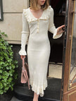 White retro ruffled knit dress by FJØRNA, featuring a vintage-inspired design with ruffles and a cozy knit texture.