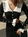 Black FJØRNA retro ruffled knit dress with a vintage-inspired design, featuring ruffles and a fitted silhouette.
