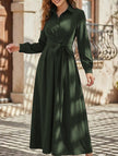 White long-sleeved dress by FJØRNA, casual and elegant, shown hanging on a wooden hanger.