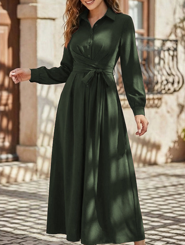 White long-sleeved dress by FJØRNA, casual and elegant, shown hanging on a wooden hanger.