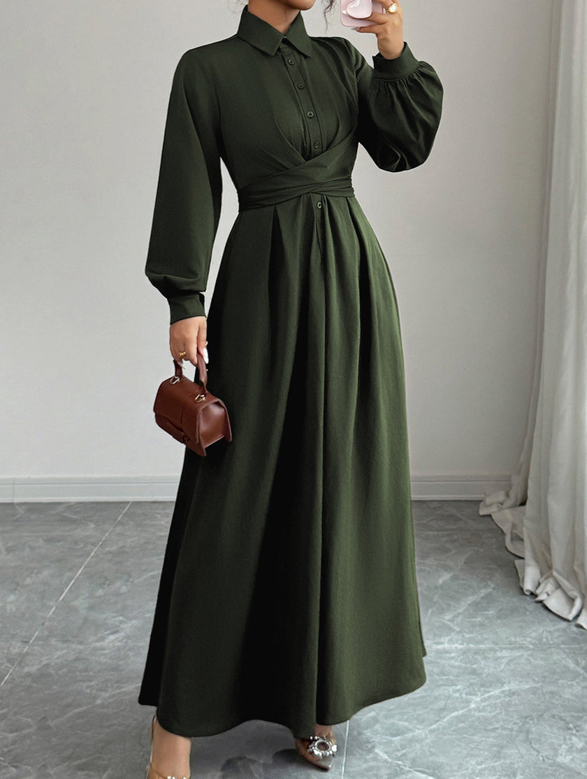 White FJØRNA long-sleeved dress with a simple, elegant design, displayed on a hanger against a neutral background.