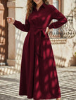 White long-sleeved dress by FJØRNA featuring a simple, elegant design, shown on a model against a neutral background.