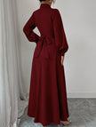 White FJØRNA long-sleeved dress with a simple, elegant design, shown on a model in a well-lit setting.