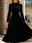 Black velvet round neck long-sleeved dress by FJØRNA, featuring a fitted silhouette and elegant design.