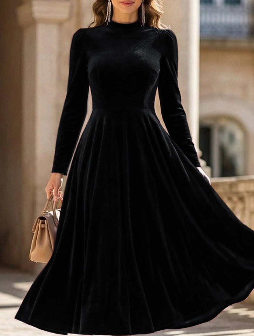 Black velvet round neck long-sleeved dress by FJØRNA, featuring a fitted silhouette and elegant design.