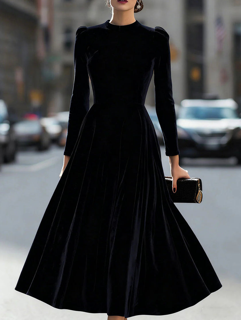 Black velvet round neck long-sleeved dress by FJØRNA, featuring a fitted silhouette and smooth fabric.