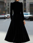 Black velvet long-sleeved round neck dress by FJØRNA, featuring a sleek, fitted silhouette and soft fabric.