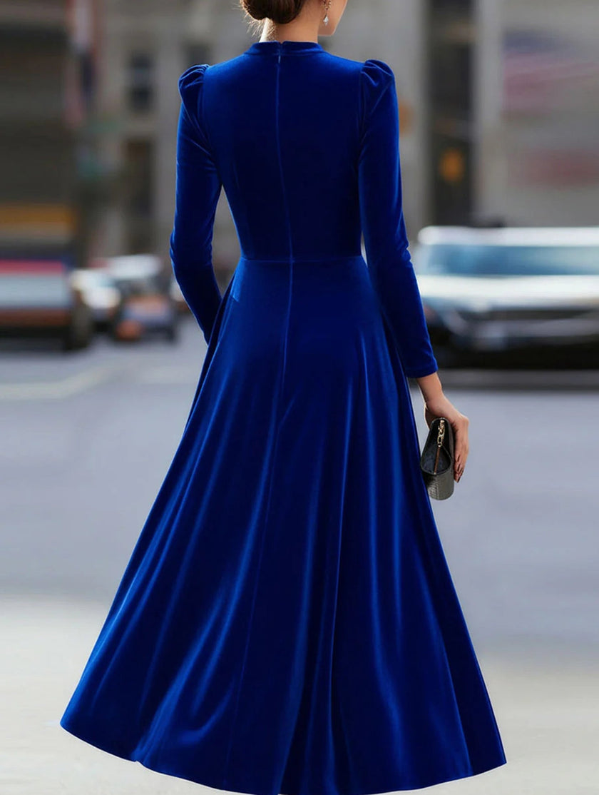 Blue velvet round neck long-sleeved dress by FJØRNA, featuring a smooth fabric and elegant fit for stylish occasions.