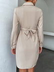 White FJØRNA cross-over fitted shirt dress, stylish and elegant with a tailored silhouette, shown on a model.