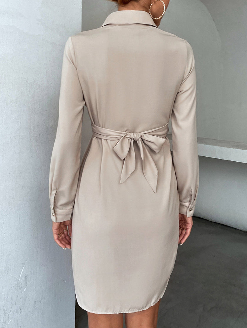 White FJØRNA cross-over fitted shirt dress, stylish and elegant with a tailored silhouette, shown on a model.