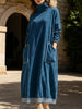 Navy blue FJØRNA relaxed turtleneck dress with long sleeves and a loose fit, styled casually.