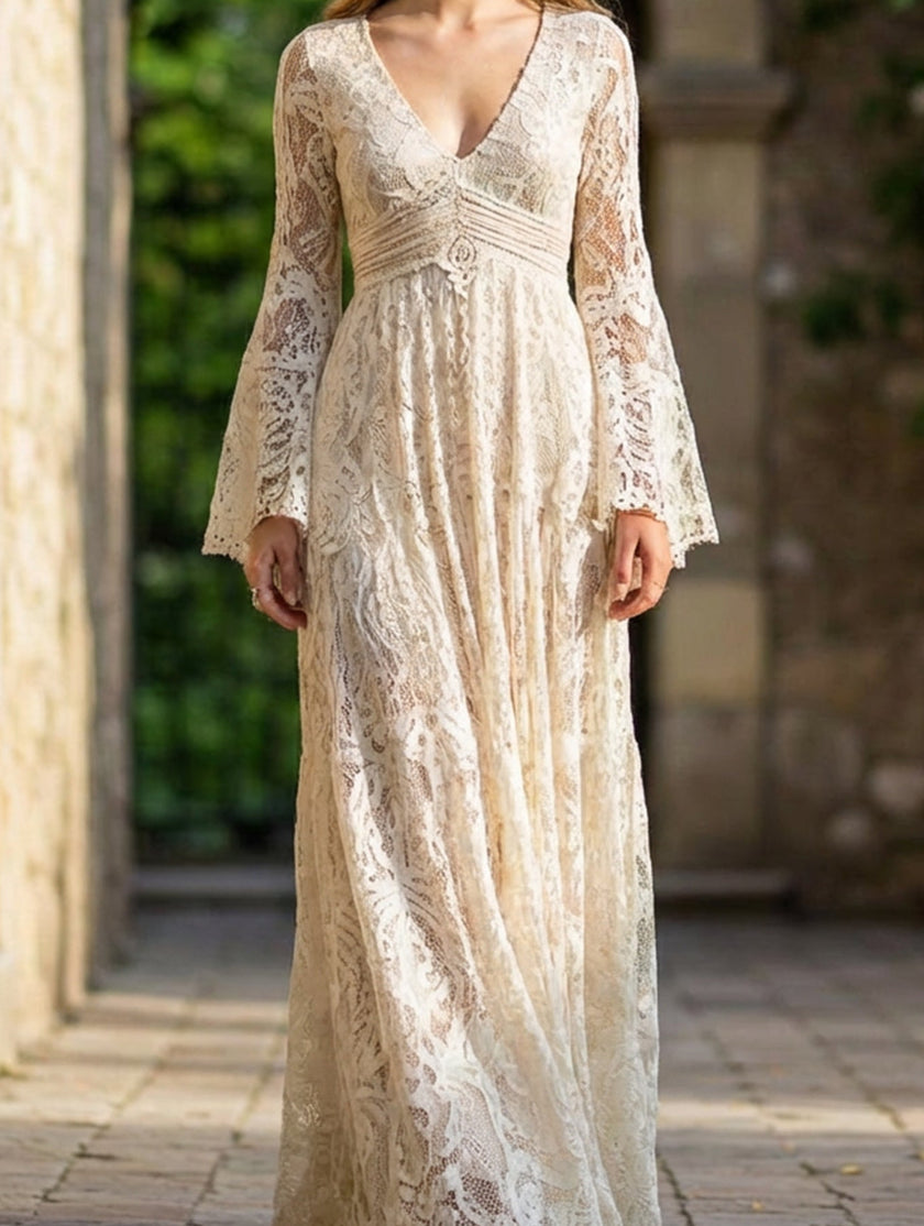 White resort-style lace bell-sleeve long dress by FJØRNA with intricate lace details and flowy bell sleeves.