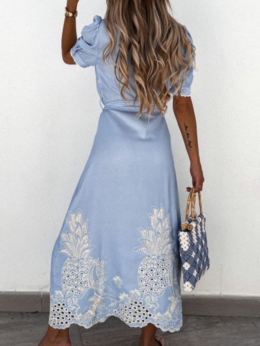 White pastoral style openwork embroidered dress by FJØRNA, featuring delicate embroidery and flowing fabric.