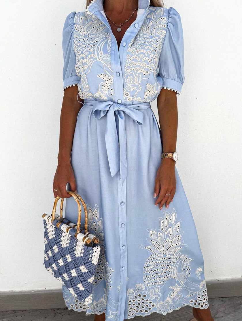 White pastoral style openwork embroidered dress by FJØRNA, featuring delicate embroidery and flowing fabric.
