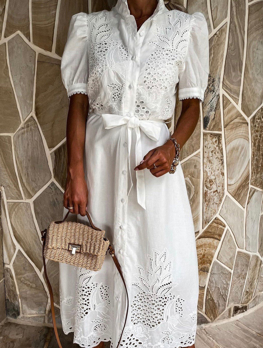 White FJØRNA pastoral style openwork embroidered dress with intricate embroidery and flowing fabric, perfect for elegant occasions.
