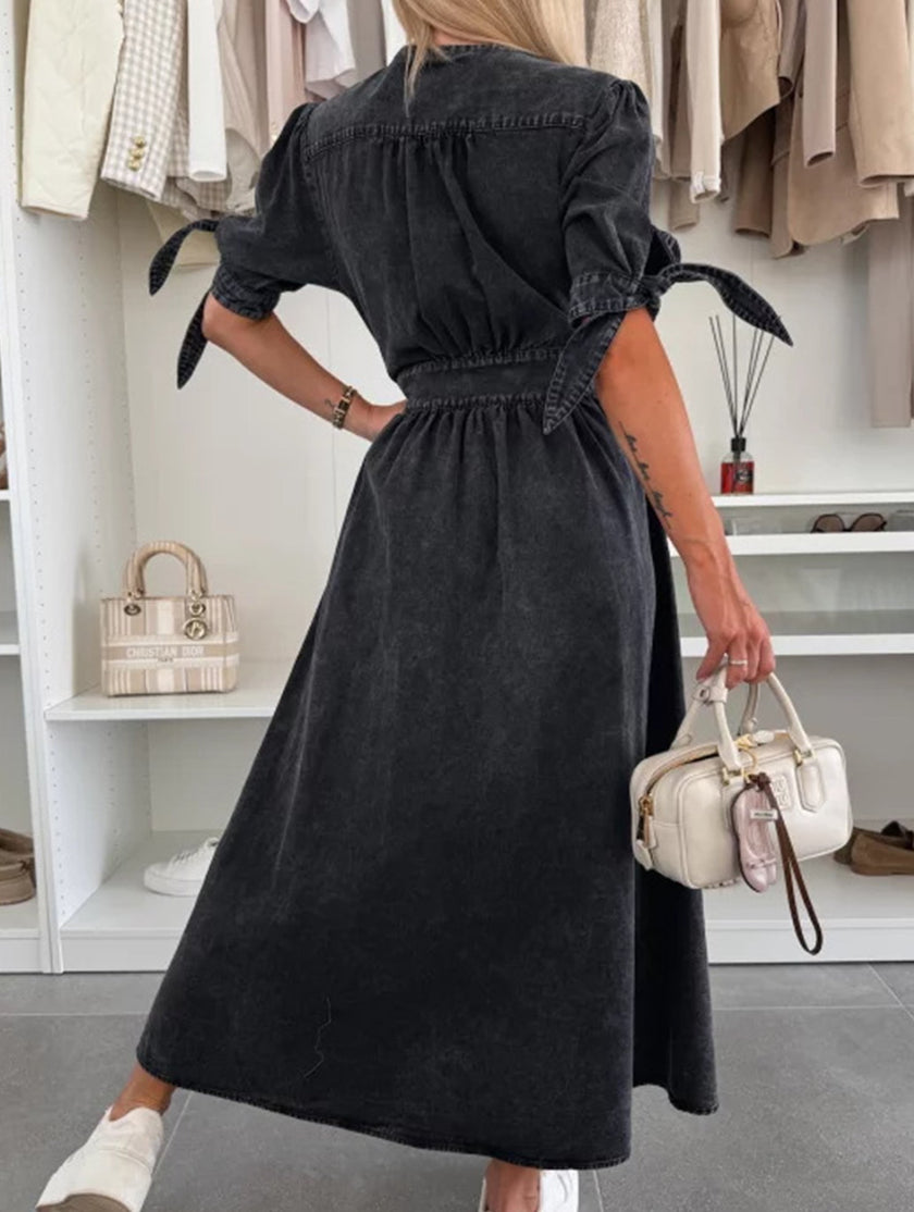 FJØRNA deep V-neck fitted shirt dress in black, showcasing a sleek, form-fitting design with long sleeves and a collar.