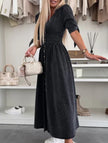 Black FJØRNA deep V-neck fitted shirt dress, stylish and elegant, shown on a model with a tailored silhouette.