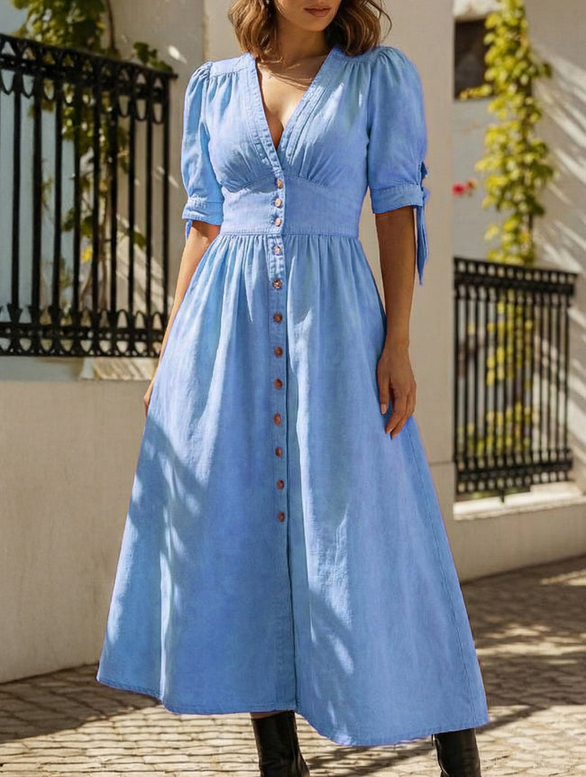 FJØRNA white fitted shirt dress with a deep V-neck, slim silhouette, long sleeves, and classic collar, shown on a model.
