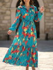 Blue printed tie-waist lantern sleeve dress by FJØRNA, featuring flowy fabric and elegant design.